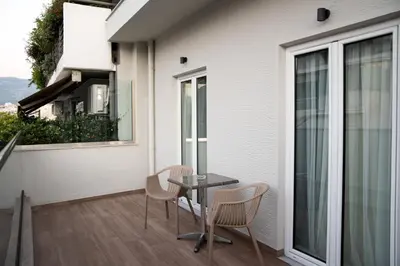 a patio with a table and chairs on a balcony at AD Athens Luxury Rooms & Suites in Athens