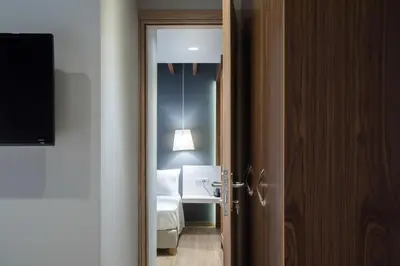 a room with a bedroom with a bed and a mirror at AD Athens Luxury Rooms & Suites in Athens