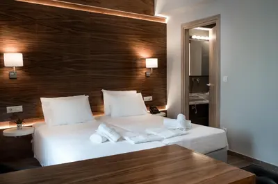 a hotel room with a bed with towels on it at AD Athens Luxury Rooms & Suites in Athens