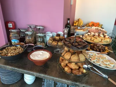 a table topped with lots of different types of food at AD Athens Luxury Rooms & Suites in Athens