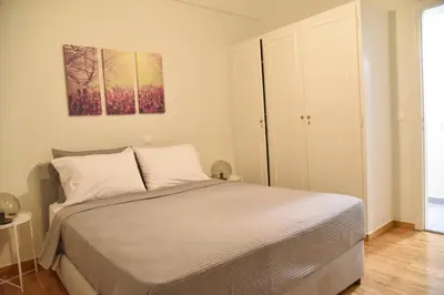 a bedroom with a bed and a painting on the wall at Perfect athens in Athens