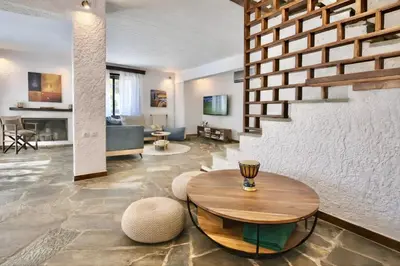 a living room with a table and a couch at Villa Naya by the Beach in Anavissos