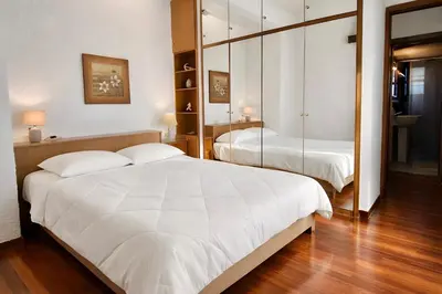a bedroom with two beds and a mirror at Villa Naya by the Beach in Anavissos