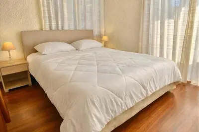 a white bed with two pillows in a bedroom at Villa Naya by the Beach in Anavissos
