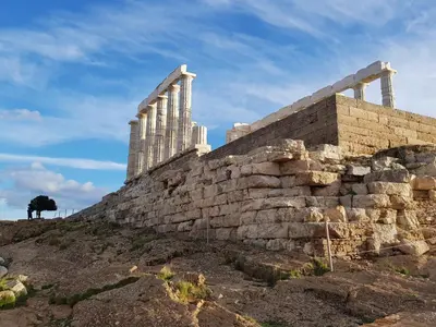 an ancient wall with a tree on a hill at Sounio Palea Heaven in Palaiá Fókaia
