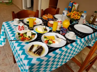 a table with plates of food and drinks on it at Sounio Palea Heaven in Palaiá Fókaia