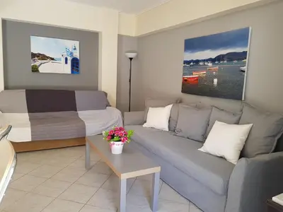 a living room with a couch and a bed at Sounio Palea Heaven in Palaiá Fókaia