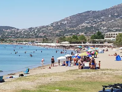 a group of people on a beach with the water at Sounio Palea Heaven in Palaiá Fókaia