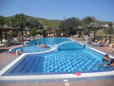 a large swimming pool with people in it at Angela Hotel in Agia Marina Aegina