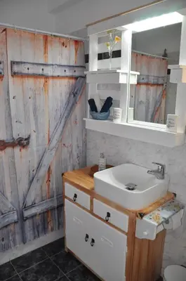 a bathroom with a sink and a wooden door at Your Home in Athens