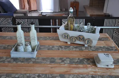 a wooden table with bottles on top of it at Your Home in Athens
