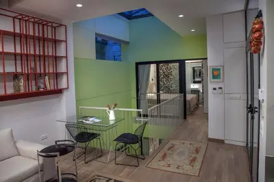 a living room with a glass table and chairs at Tripodon Plaka In the shade of Acropolis by GHH in Athens