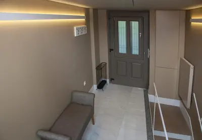 a hallway with a door and a bench and a stairway at Tripodon Plaka In the shade of Acropolis by GHH in Athens