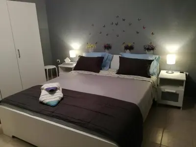 a bedroom with a large bed with a pillow on it at Charilaou Trikoupi Flat in Athens