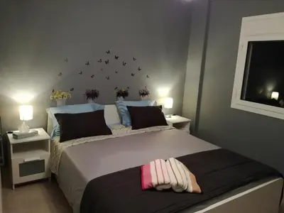 a bedroom with a large bed with flowers on the wall at Charilaou Trikoupi Flat in Athens