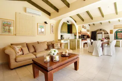 a living room with a couch and a table at Oasis Pool House by GHH in Lagonissi