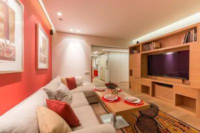 a living room with a couch and a tv at Unique Acropolis View in Athens