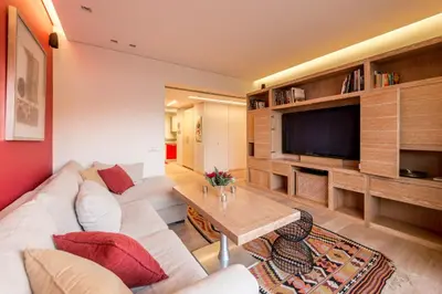 a living room with a white couch and a television at Unique Acropolis View in Athens