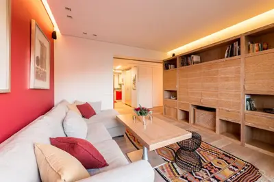 a living room with a white couch and a table at Unique Acropolis View in Athens