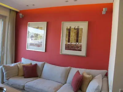 a living room with a couch against a red wall at Unique Acropolis View in Athens