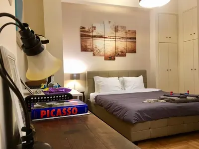 a bedroom with two beds and a lamp at Elegant Studio in Kolonaki-Top Location! in Athens