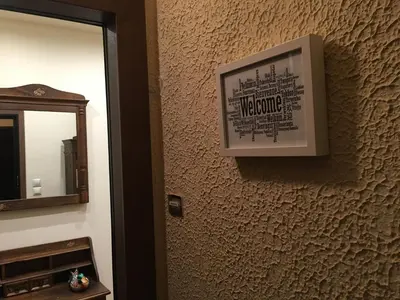 a picture on the wall of a bathroom with a mirror at Elegant Studio in Kolonaki-Top Location! in Athens