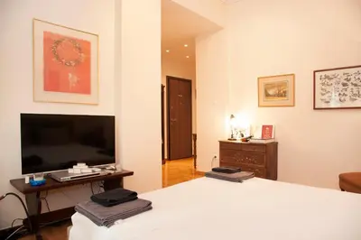 a bedroom with a large bed and a television at Elegant Studio in Kolonaki-Top Location! in Athens