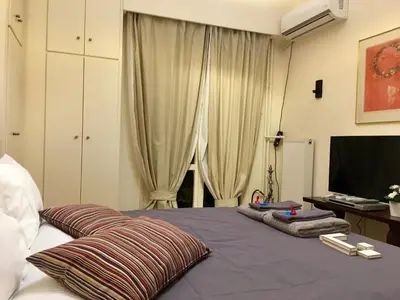 a bedroom with a bed with towels on it at Elegant Studio in Kolonaki-Top Location! in Athens
