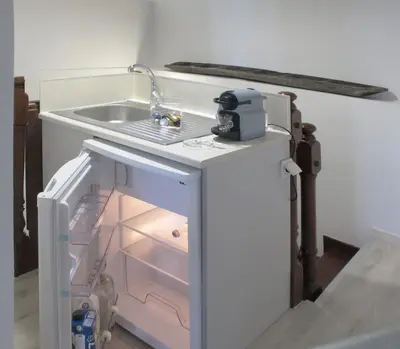 a kitchen with a sink and an open refrigerator at Athenian House in Plaka Villa by Athenian Homes in Athens