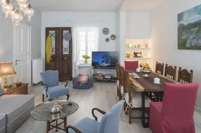 a living room with a table and a dining room at Athenian House in Plaka Villa by Athenian Homes in Athens