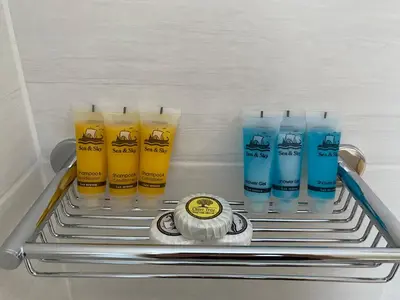 a shelf in a refrigerator with four different colored glasses at Georgina in Agia Marina Aegina