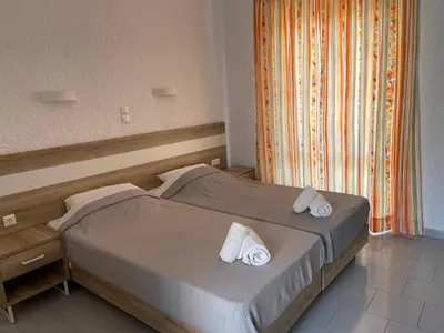 a bedroom with two beds with towels on them at Georgina in Agia Marina Aegina