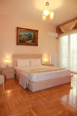 a bedroom with a bed and a painting on the wall at Olga's Studio in Athens