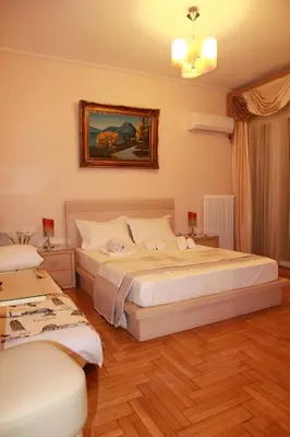 a bedroom with a bed and a painting on the wall at Olga's Studio in Athens