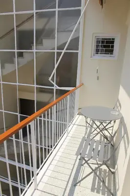 a chair sitting on the balcony of a building at Olga's Studio in Athens