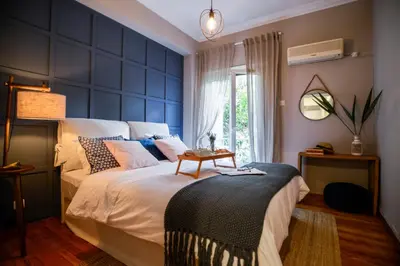 a bedroom with a large bed with a blue wall at Your 