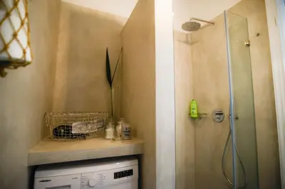 a bathroom with a shower and a washing machine at Your 