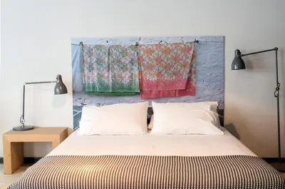 a bedroom with a bed and two hanging blankets at we saw athens in Athens
