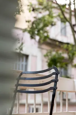 a wooden bench sitting in front of a building at we saw athens in Athens