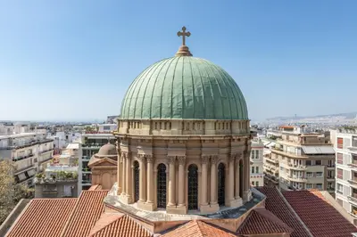 a church with a green dome on top of a building at TOP Kolonaki Studio+Terrace Stunning Acropolis Views in Athens