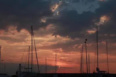 a group of boats parked in a harbor with a sunset at Unique Flat with Sea View at Edem Beach - A Seafront Property by Athenian Homes in Athens