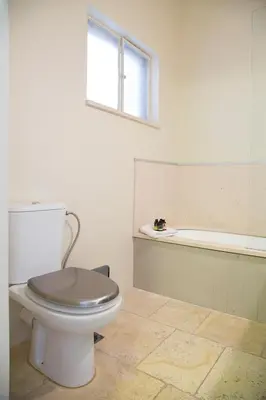 a bathroom with a toilet and a bath tub at Beautiful Penthouse in Athens with outdoor jacuzzi in Athens