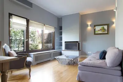 a living room with a couch and a tv at Beautiful Penthouse in Athens with outdoor jacuzzi in Athens