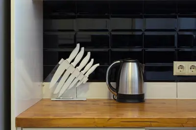a coffee pot and a knife holder on a counter at Beautiful Penthouse in Athens with outdoor jacuzzi in Athens