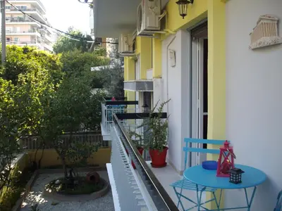 a balcony with two blue tables and a window at KOKONI APARTMENTS AMBELOKIPI, ATHENS in Athens