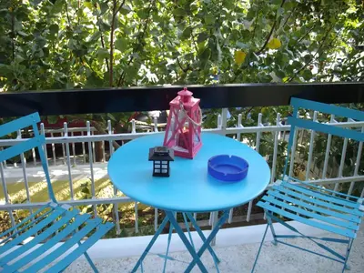 a blue table with a lantern sitting between two chairs at KOKONI APARTMENTS AMBELOKIPI, ATHENS in Athens