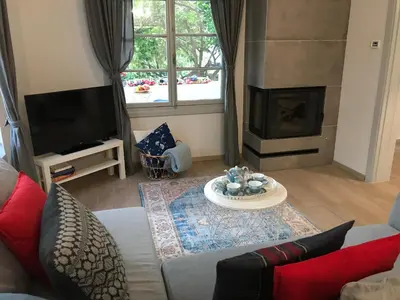 a living room with a couch and a fireplace at Dina's House in Spáta