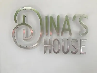 a sign for aimax house hanging on a wall at Dina's House in Spáta