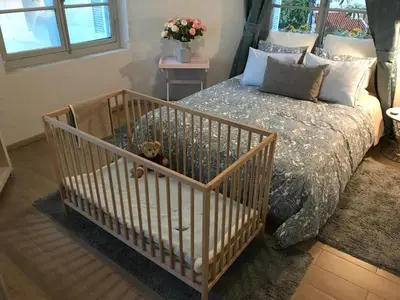 a crib with a teddy bear in a bedroom at Dina's House in Spáta