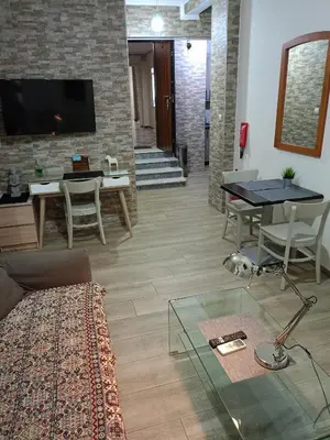 a living room with a couch and a table at Athens Center Cosy Apartment in Athens